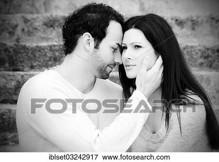 "Young man holding a young woman's head, Austria, Europe" View Large Photo Image Stock Photo - "Young man holding a young woman's head, Austria, Europe". Fotosearch