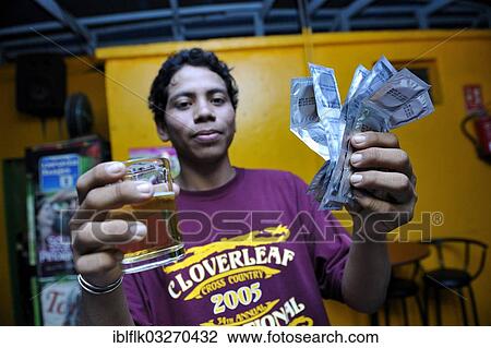 "Young man in a brothel holding a beer and condoms in his hand, protection against AIDS and other sexually transmitted diseases, Masaya, Departamento Masaya, Nicaragua, North America" View Large Photo Image Stock Image - "Young man in a brothel holding a beer and condoms in his hand, protection against AIDS and other sexually transmitted diseases, Masaya, Departamento Masaya, Nicaragua, North America". Fotosearch