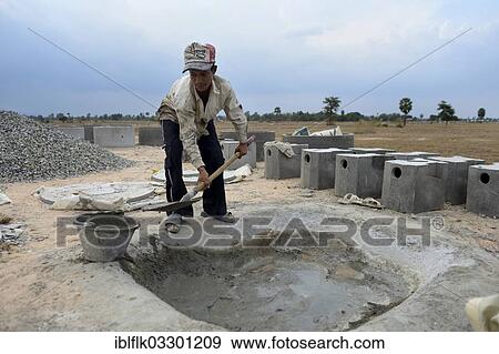 "Young man in a local construction company mixing cement to produce parts for latrines, rear, Tropeng Village, Bathi District, Takeo Province, Cambodia, Asia" View Large Photo Image Stock Photo - "Young man in a local construction company mixing cement to produce parts for latrines, rear, Tropeng Village, Bathi District, Takeo Province, Cambodia, Asia". Fotosearch