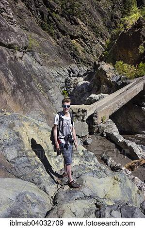 "Young man on a hiking trail in the Caldera de Taburiente, stream, Caldera de Taburiente National Park, La Palma, Canary Islands, Spain, Europe" View Large Photo Image Stock Photo - "Young man on a hiking trail in the Caldera de Taburiente, stream, Caldera de Taburiente National Park, La Palma, Canary Islands, Spain, Europe". Fotosearch