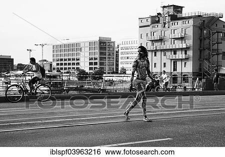 "Young man painted in Polynesian patterns crossing a major road, Berlin, Germany, Europe" View Large Photo Image Stock Photograph - "Young man painted in Polynesian patterns crossing a major road, Berlin, Germany, Europe". Fotosearch
