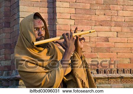 "Young man playing flute at the burning ghats, Kathmandu, Kathmandu District, Bagmati Zone, Nepal, Asia" View Large Photo Image Stock Image - "Young man playing flute at the burning ghats, Kathmandu, Kathmandu District, Bagmati Zone, Nepal, Asia". Fotosearch