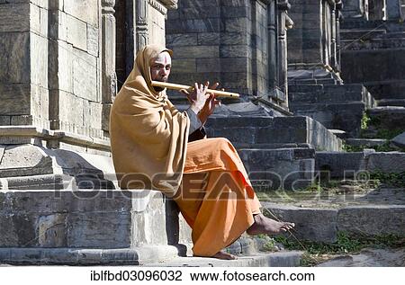 "Young man playing flute at the burning ghats, Kathmandu, Kathmandu District, Bagmati Zone, Nepal, Asia" View Large Photo Image Stock Image - "Young man playing flute at the burning ghats, Kathmandu, Kathmandu District, Bagmati Zone, Nepal, Asia". Fotosearch
