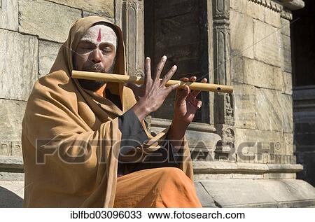 "Young man playing flute at the burning ghats, Kathmandu, Kathmandu District, Bagmati Zone, Nepal, Asia" View Large Photo Image Stock Image - "Young man playing flute at the burning ghats, Kathmandu, Kathmandu District, Bagmati Zone, Nepal, Asia". Fotosearch