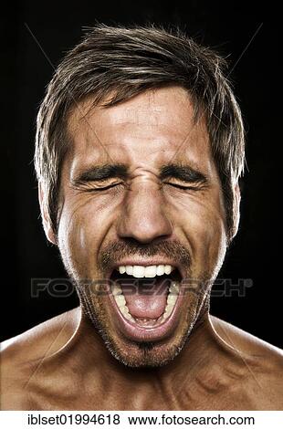Stock Photo - "Young man screaming, portrait". Fotosearch