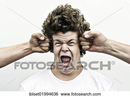 Stock Photograph - "Young man shouting while being attacked by fists, headache". Fotosearch