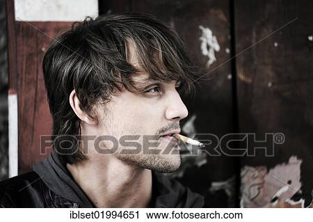 "Young man smoking, portrait" View Large Photo Image Stock Image - "Young man smoking, portrait". Fotosearch