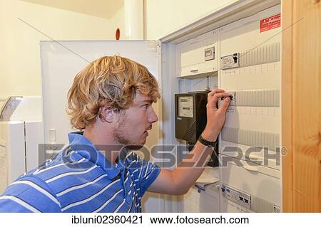 Young man turning off a fuse in a fuse box View Large Photo Image Stock Image - Young man turning off a fuse in a fuse box. Fotosearch