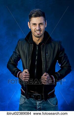 Picture - Young man wearing a black leather jacket. Fotosearch