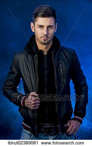 Stock Image - Young man wearing a black leather jacket. Fotosearch