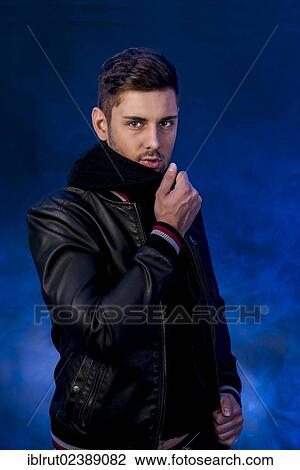 Stock Image - Young man wearing a black leather jacket. Fotosearch