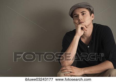 "Young man wearing a peaked cap, Mannheim, Baden-Wurttemberg, Germany, Europe" View Large Photo Image Stock Photo - "Young man wearing a peaked cap, Mannheim, Baden-Wurttemberg, Germany, Europe". Fotosearch