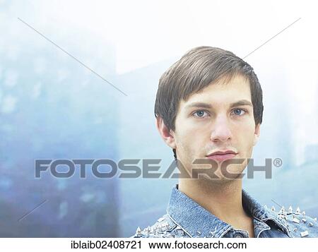 Stock Image - "Young man with a serious face, portrait". Fotosearch