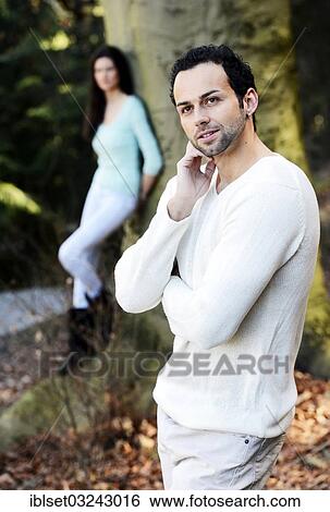"Young man with a young woman leaning against a tree at back, Austria, Europe" View Large Photo Image Stock Photograph - "Young man with a young woman leaning against a tree at back, Austria, Europe". Fotosearch