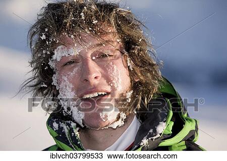 Stock Image - "Young man with his face full of snow, portrait". Fotosearch