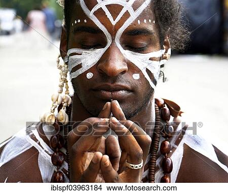 Picture - "Young man with Polynesian war paint, prayer pose, Berlin, Germany, Europe". Fotosearch