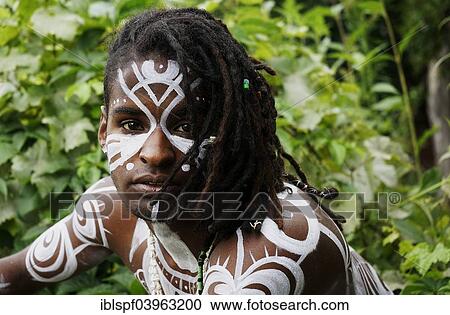 Stock Image - "Young man with Polynesian war paint and dreadlocks, portrait, Berlin, Germany, Europe". Fotosearch