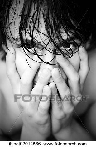 Stock Photograph - Young man with wet hair and his hands on his face. Fotosearch