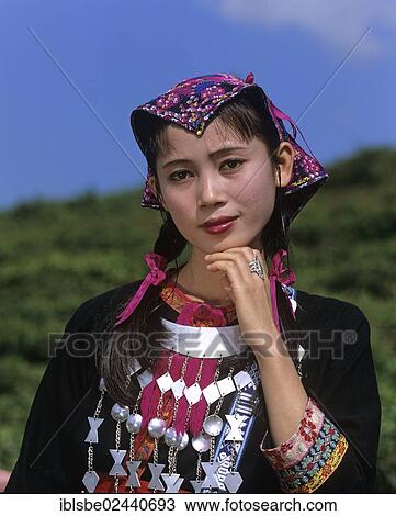 Stock Image - "Young Miao woman wearing a traditional ethnic costume, portrait, Hainan, China, Asia". Fotosearch