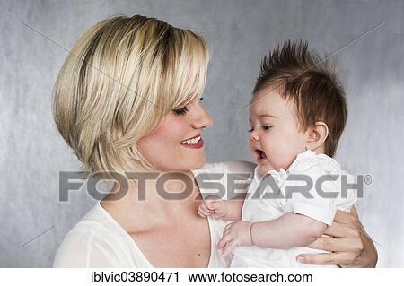 Stock Image - "Young mother with baby, 5 months, Germany, Europe". Fotosearch
