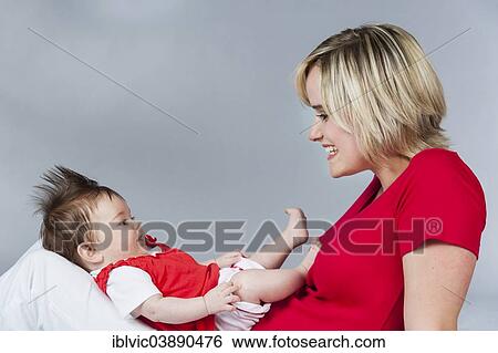 Stock Photograph - "Young mother with baby, 5 months, Germany, Europe". Fotosearch