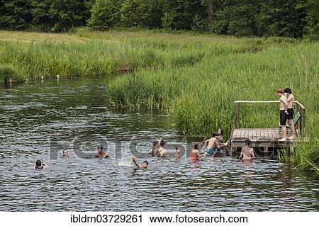 "Young people bathing in the Krutynia River, Ukta, Warmian-Masurian Voivodeship, Poland, Europe" View Large Photo Image Stock Image - "Young people bathing in the Krutynia River, Ukta, Warmian-Masurian Voivodeship, Poland, Europe". Fotosearch