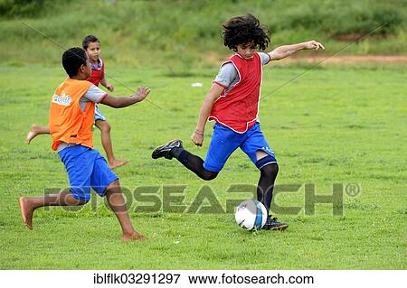 Stock Photo - "Young people playing football, social project in a favela, Poxoreo, Mato Grosso, Brazil, South America". Fotosearch
