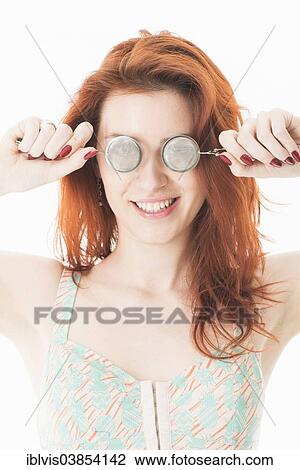 Young red-haired woman holding tea infusers in front of her eyes View Large Photo Image Stock Image - Young red-haired woman holding tea infusers in front of her eyes. Fotosearch