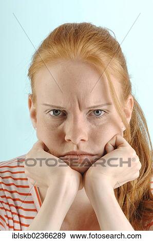 "Young red-haired woman, looking grimly with a furrowed brow, Portrait" View Large Photo Image Stock Photo - "Young red-haired woman, looking grimly with a furrowed brow, Portrait". Fotosearch