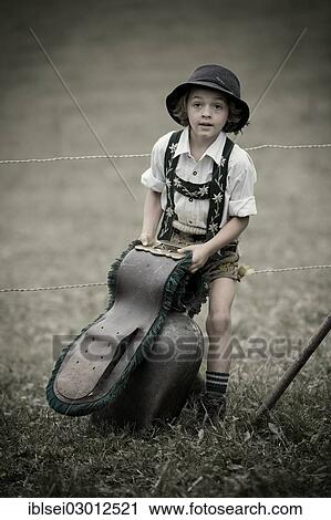 Stock Image - "Young shepherd with a large bell during the Viehscheid cattle drive, Gunzesried, Allgau, Bavaria, Germany, Europe". Fotosearch