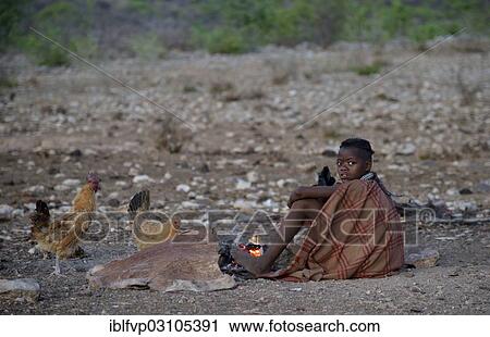 "Young shepherdess from the Himba people sitting by a campfire, Ombombo, Kaokoland, Kunene, Namibia, Africa" View Large Photo Image Stock Image - "Young shepherdess from the Himba people sitting by a campfire, Ombombo, Kaokoland, Kunene, Namibia, Africa". Fotosearch