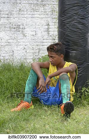 "Young soccer player, street child, leaning out of breath against a pole, during the preparation for the Street Children World Cup 2014, Fortaleza, Ceara, Brazil, South America" View Large Photo Image Stock Image - "Young soccer player, street child, leaning out of breath against a pole, during the preparation for the Street Children World Cup 2014, Fortaleza, Ceara, Brazil, South America". Fotosearch
