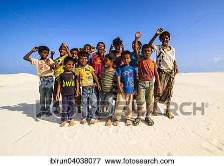 "Young Socotrian boys posing in the sand dunes at the south coast of the island of Socotra, Yemen, Asia" View Large Photo Image Stock Photo - "Young Socotrian boys posing in the sand dunes at the south coast of the island of Socotra, Yemen, Asia". Fotosearch