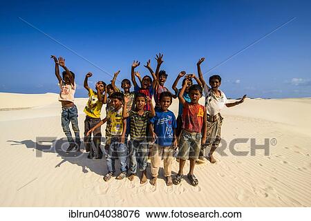 Stock Photograph - "Young Socotrian boys posing in the sand dunes at the south coast of the island of Socotra, Yemen, Asia". Fotosearch
