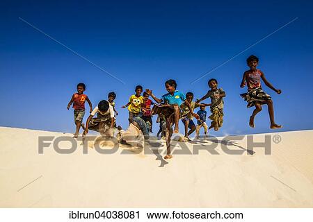 "Young Socotrian boys running in the sand dunes at the south coast of the island of Socotra, Yemen, Asia" View Large Photo Image Stock Image - "Young Socotrian boys running in the sand dunes at the south coast of the island of Socotra, Yemen, Asia". Fotosearch