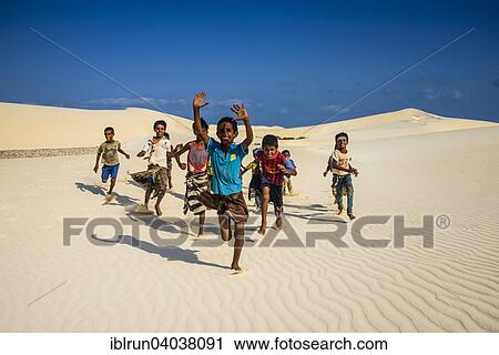 "Young Socotrian boys running in the sand dunes at the south coast of the island of Socotra, Yemen, Asia" View Large Photo Image Stock Image - "Young Socotrian boys running in the sand dunes at the south coast of the island of Socotra, Yemen, Asia". Fotosearch