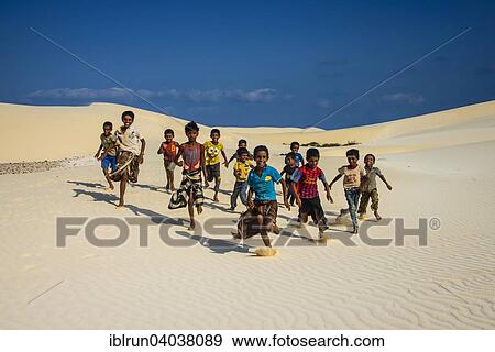 "Young Socotrian boys running in the sand dunes at the south coast of the island of Socotra, Yemen, Asia" View Large Photo Image Stock Photo - "Young Socotrian boys running in the sand dunes at the south coast of the island of Socotra, Yemen, Asia". Fotosearch