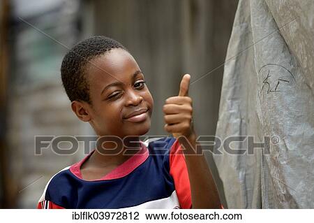 "Young winking and giving his thumbs up, Camp Icare for earthquake refugees, Fort National, Port-au-Prince, Haiti, North America" View Large Photo Image Stock Image - "Young winking and giving his thumbs up, Camp Icare for earthquake refugees, Fort National, Port-au-Prince, Haiti, North America". Fotosearch