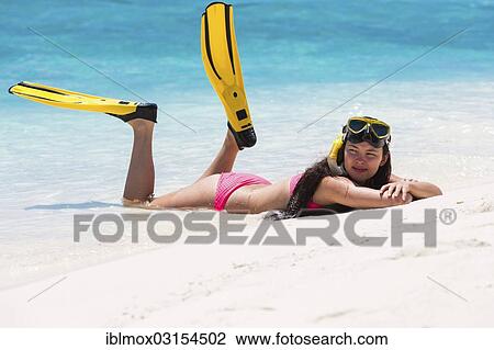 "Young woman, about 20, lying on a sandbank with snorkeling gear, Indian Ocean, Male, North Male Atoll, Maldives, Asia" View Large Photo Image Stock Image - "Young woman, about 20, lying on a sandbank with snorkeling gear, Indian Ocean, Male, North Male Atoll, Maldives, Asia". Fotosearch