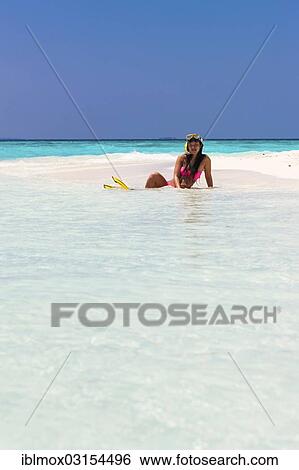 "Young woman, about 20, sitting on a sandbank with snorkeling gear, Indian Ocean, Male, North Male Atoll, Maldives, Asia" View Large Photo Image Stock Photograph - "Young woman, about 20, sitting on a sandbank with snorkeling gear, Indian Ocean, Male, North Male Atoll, Maldives, Asia". Fotosearch