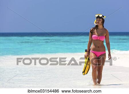 "Young woman, about 20, walking over a sandbank with snorkeling gear, Indian Ocean, Male, North Male Atoll, Maldives, Asia" View Large Photo Image Stock Photograph - "Young woman, about 20, walking over a sandbank with snorkeling gear, Indian Ocean, Male, North Male Atoll, Maldives, Asia". Fotosearch