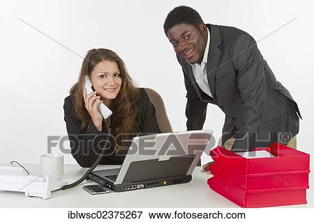 Young woman and a young man in the office View Large Photo Image Stock Photo - Young woman and a young man in the office. Fotosearch