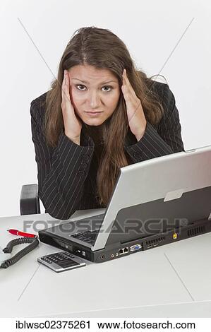 "Young woman at her desk with a laptop computer, headache" View Large Photo Image Stock Image - "Young woman at her desk with a laptop computer, headache". Fotosearch