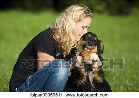 "Young woman cuddling an Australian Shepherd dog, Austria, Europe" View Large Photo Image Stock Image - "Young woman cuddling an Australian Shepherd dog, Austria, Europe". Fotosearch