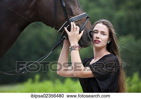"Young woman cuddling with a Hanoverian horse, bay, North Tyrol, Austria, Europe" View Large Photo Image Stock Image - "Young woman cuddling with a Hanoverian horse, bay, North Tyrol, Austria, Europe". Fotosearch
