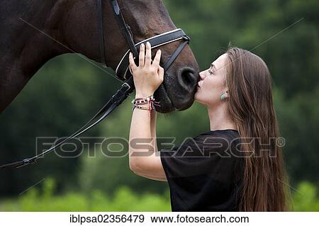 "Young woman cuddling with a Hanoverian horse, bay, North Tyrol, Austria, Europe" View Large Photo Image Stock Photo - "Young woman cuddling with a Hanoverian horse, bay, North Tyrol, Austria, Europe". Fotosearch