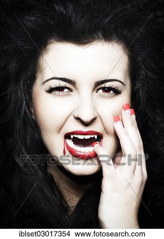 "Young Woman dressed as a vampire with blood on her red lips, Austria, Europe" View Large Photo Image Picture - "Young Woman dressed as a vampire with blood on her red lips, Austria, Europe". Fotosearch