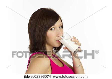 Picture - Young woman drinking a glass of milk. Fotosearch