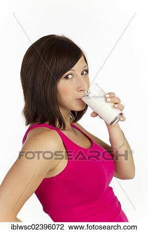 Young woman drinking a glass of milk View Large Photo Image Stock Image - Young woman drinking a glass of milk. Fotosearch