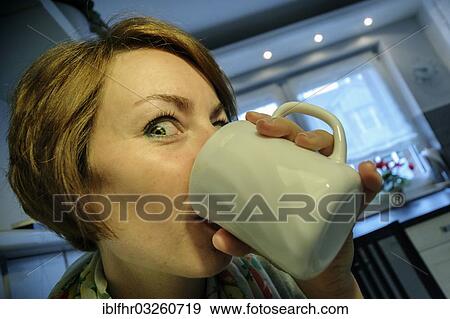 "Young woman drinking coffee enthusiastically, Germany, Europe" View Large Photo Image Stock Photo - "Young woman drinking coffee enthusiastically, Germany, Europe". Fotosearch